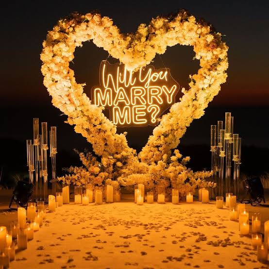 Romantic proposal decoration setup by Xplore Events with candles and rose petals