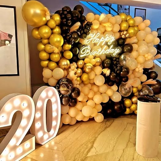 Birthday celebration setup with balloons and gold accents by Xplore Events