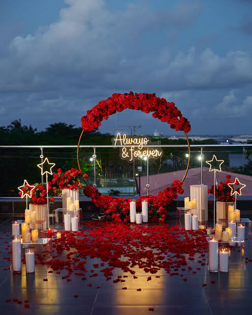 Romantic rooftop proposal setup with flowers and candles
