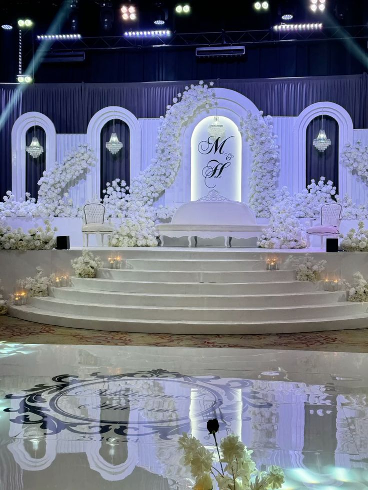 Luxury wedding hall decoration with floral arrangements and lighting by Xplore Events